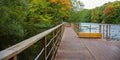 Bridge and walking wooden path over the lake on an autumn morning