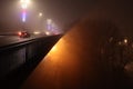 Bridge yellow light in a foggy night