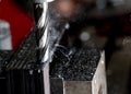 Bridgeport CNC end mill finishing a stack of steel plate with metal filings chips and light smoke