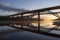 Bridges reflected in water at beautiful, early dawn.