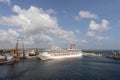 Bridgetown, Barbados - May 2, 2020: Carnival Valor docked in the port of Bridgetown. Beautiful blue sky, white clouds, port and