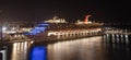 Bridgetown, Barbados - May 1, 2020: Carnival Valor docked in the port of Bridgetown at night. Beautiful reflections on the water
