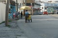 Street vendor on the road with typical houses in bright colors and colonial style on the Caribbean island of Barbados.