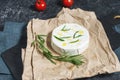 Brie or Camembert cheese with rosemary on a black stone background Royalty Free Stock Photo