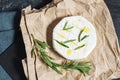 Brie or Camembert cheese with rosemary on a black stone background Royalty Free Stock Photo