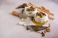 Brie or camembert cheese with thyme, nuts, honey and grissini breadstick Royalty Free Stock Photo