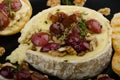 Brie cheese baked with nuts and grapes Royalty Free Stock Photo