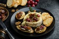 Brie cheese baked with nuts and grapes Royalty Free Stock Photo