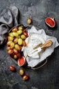 Brie cheese, figs, green grapes. Wine appetizers, antipasti snacks. Cheese and fruit platter