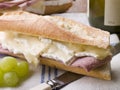 Brie and Ham Baguette with White Wine and Grapes Royalty Free Stock Photo