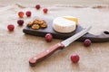 Brie type of cheese. Camembert cheese. Fresh Brie cheese on a wooden board with nuts and grapes. Italian, French cheese. Royalty Free Stock Photo