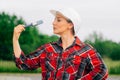 The brigadier is a young girl wistfully standing . A woman wearing a protective helmet. The concept of construction work Royalty Free Stock Photo