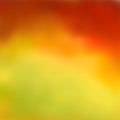 Bright abstract autumn background, beautiful blurred color transition from reds and browns to yellow-green