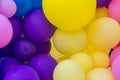 Bright abstract background of jumble of rainbow colored balloons, celebrating