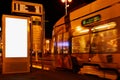 Night scene at tram stop with blank advertising panel Royalty Free Stock Photo