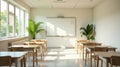 Bright, airy classroom with sunlight streaming through large windows, illuminating empty desks and a whiteboard, creating a serene Royalty Free Stock Photo