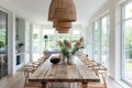 Bright, airy dining room with a rustic wooden table and wicker lamps