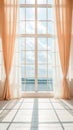 Sunlit room with large window and peach curtains overlooking a cloudy sky Royalty Free Stock Photo