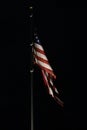 Bright american flag flapping and flying high in night