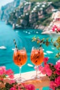 Bright Aperol Spritz cocktails with Mediterranean coastline as a backdrop.