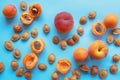 Bright apricots and peaches and fruit stones on blue