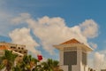 Bright architecture with folk ornaments on facade tiles with tiled roofs, palm trees against background of beautiful