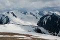 Bright atmospheric scenery on top of mountain ridge above clouds in thick low clouds. Beautiful landscape with spotted mountain Royalty Free Stock Photo