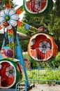 Amusement in a children`s Park, swings, carousels on the background of green trees. Royalty Free Stock Photo