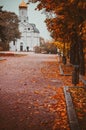 Bright autumn alley leading to the church