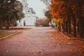 Bright autumn alley leading to the church