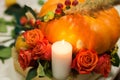 The bright autumn arrangement of flowers and berries in the pumpkin