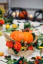 The bright autumn arrangement of flowers and berries in the pumpkin