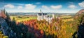 Bright autumn panorama of Neuschwanstein Castle Schloss Neuschwanstein in in Fussen Germany. Colorful morning scene in Bavarian