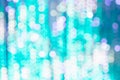 Bright background from blurry bokeh of Christmas lights in turquoise and white. Holiday concept, background, christmas