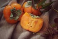 bright background. ripe orange persimmon on a beige background. beautiful background texture. juicy fruits. vitamins