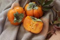 bright background. ripe orange persimmon on a beige background. beautiful background texture. juicy fruits. vitamins