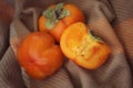 bright background. ripe orange persimmon on a beige background. beautiful background texture. juicy fruits. vitamins