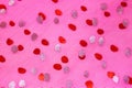 Pink fabric with red and silver dots.