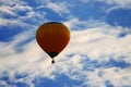 Bright balloon in blue sky with clouds