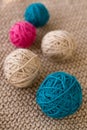 Bright balls of yarn lying on knitted plaid