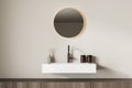 Bright bathroom interior with sink and round mirror Royalty Free Stock Photo