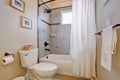 Bright bathroom nwith white shower curtain.