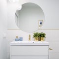 Bright bathroom with round mirror Royalty Free Stock Photo