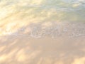 Bright beach background, movement of clear sea water and wave surf on clean sandy beach ocean, seashore scene, coastline. Royalty Free Stock Photo