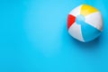 Bright beach ball on light blue background, top view. Space for text Royalty Free Stock Photo