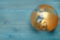 Bright beach ball on light blue wooden background, top view. Space for text Royalty Free Stock Photo