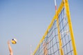 Bright beach scene with a net and volley ball at sunset Royalty Free Stock Photo