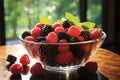 Bright and beautiful breakfast arrangement of fresh berries against sunlit window