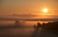 Bright beautiful dawn, the sun rises over the city, the light passes through the fog Royalty Free Stock Photo