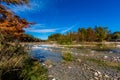 Bright Beautiful Fall Foliage on the Crystal Clear Frio River. Royalty Free Stock Photo